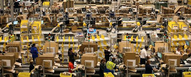 More than a warehouse? Employees process customer orders at Amazon.com’s fulfillment center in Britain. (©Chris Ratcliffe/Bloomberg via Getty Images)